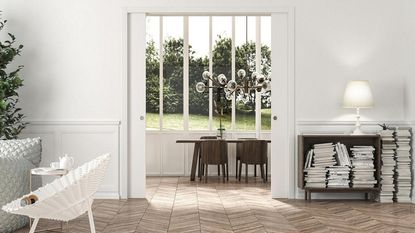 White pocket doors in open plan space with wood flooring and table