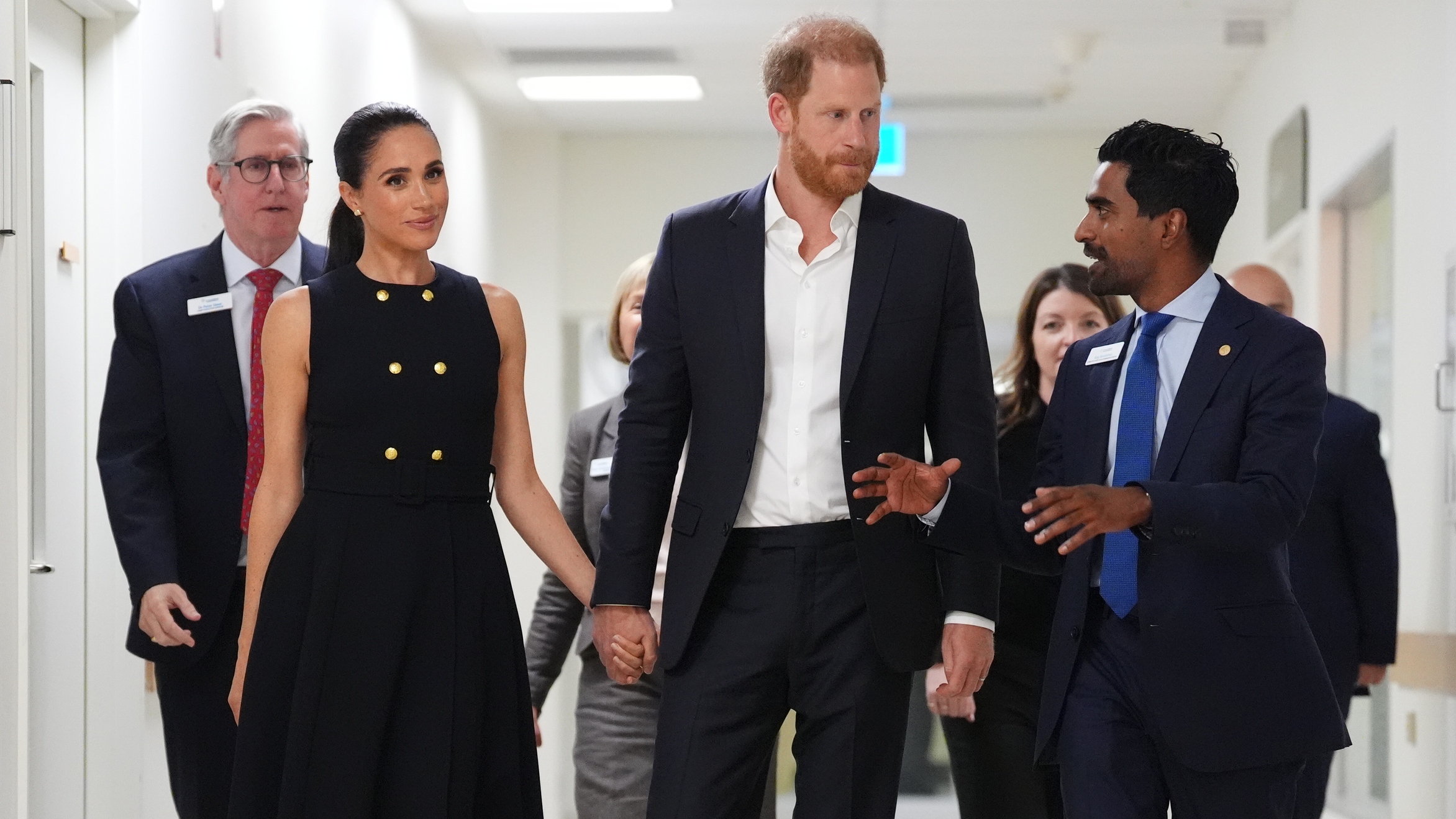 Meghan, Duchess of Sussex and Prince Harry talk with Kog Ravindran, chief of staff to the CEO &amp;amp; executive director of communications at the Royal Children's Hospital