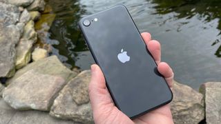 iPhone SE 2020 back in front of water and rocks