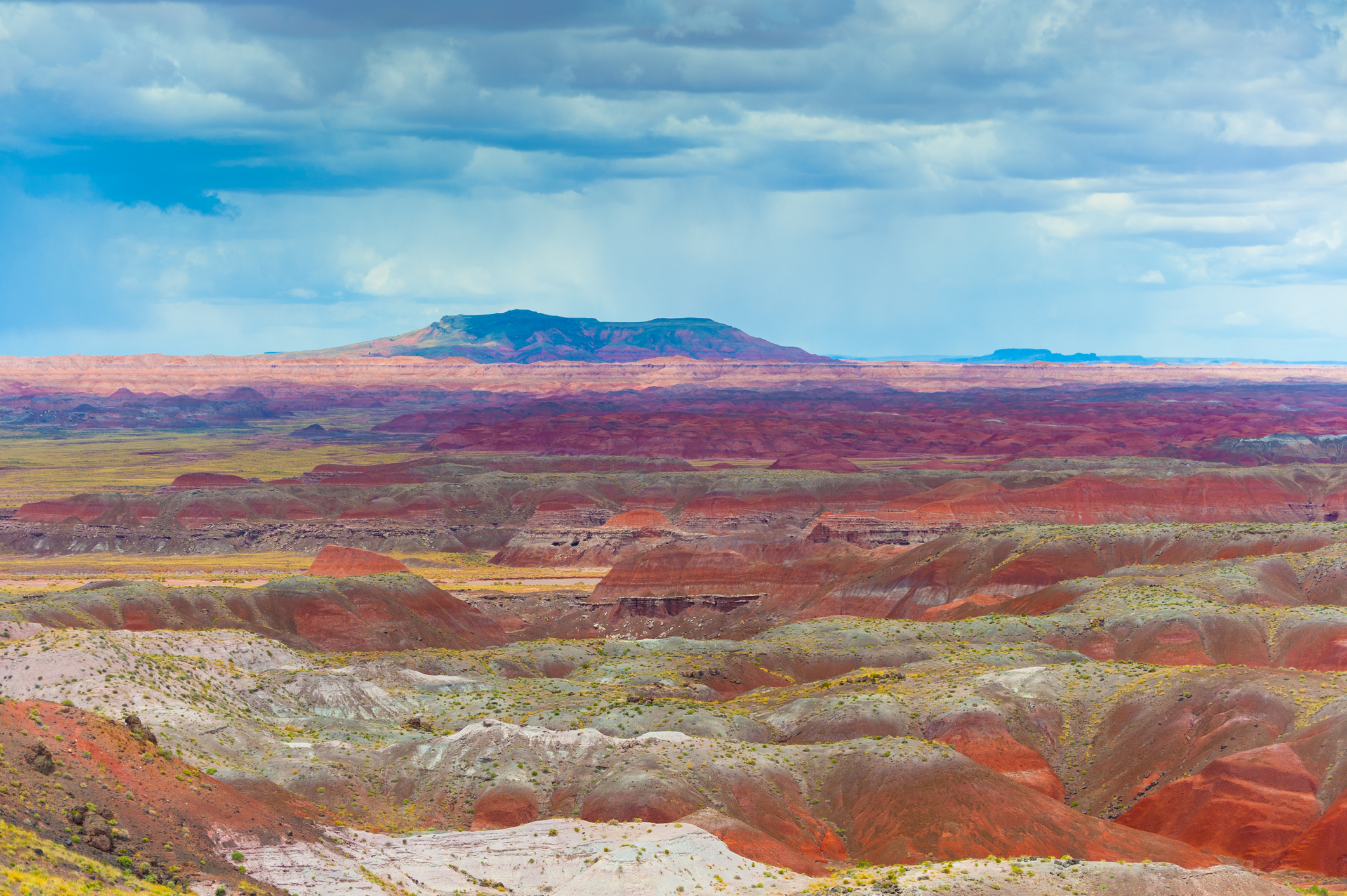 Painted Desert rock formations with vibrant blues, purples, oranges, and peaches.