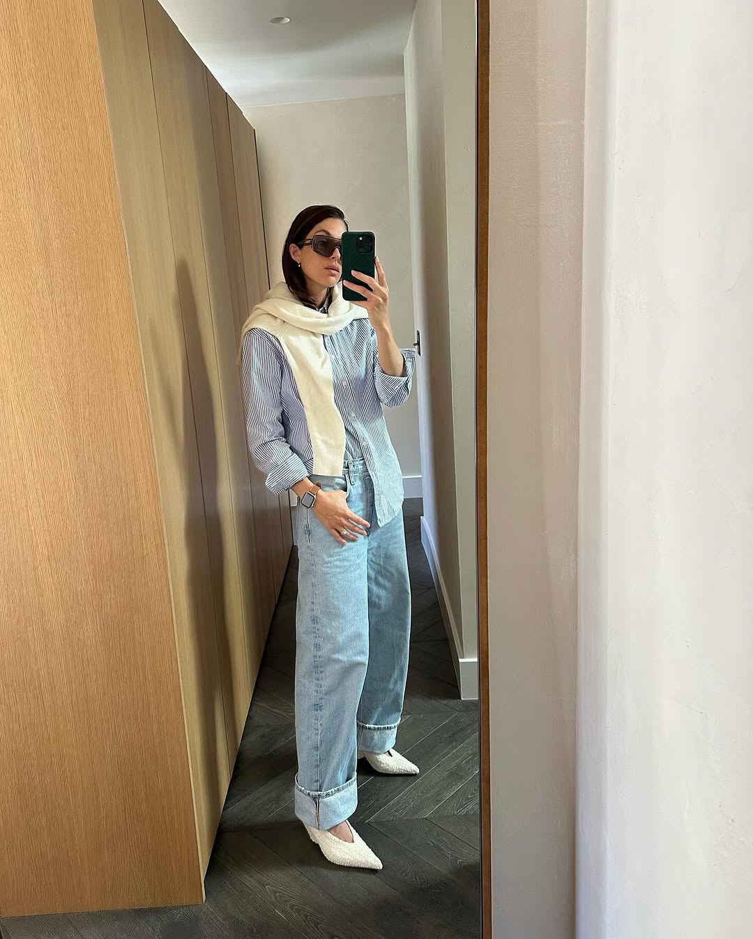 Woman wearing a sweater styling idea for 2025 in summer.