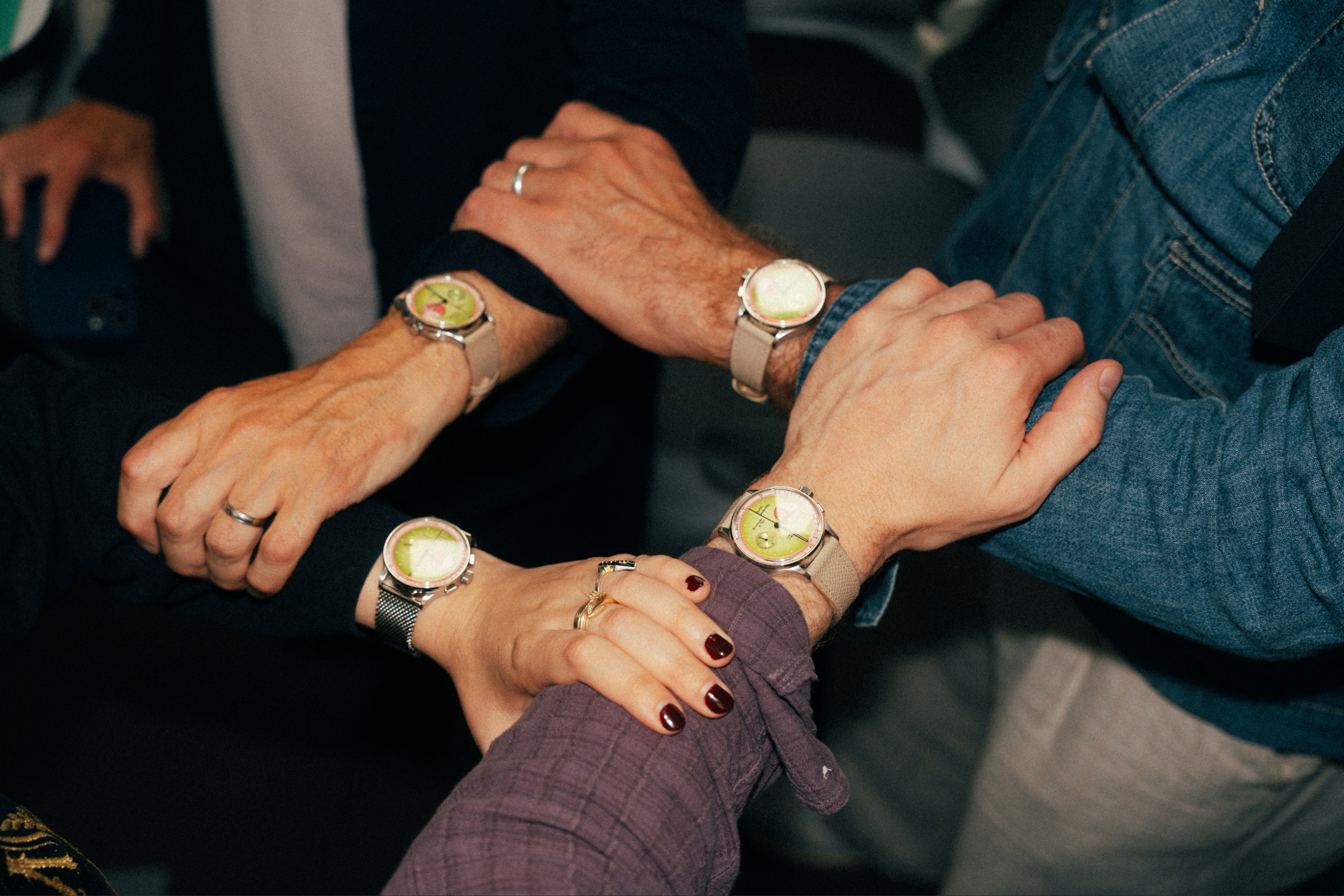 Four hands grasping four wrists