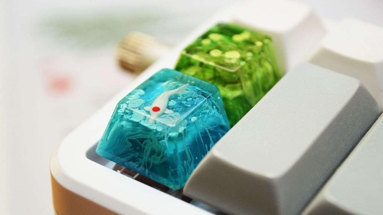 Jelly Key koi pond key caps on Novelkeys mouse pad with camping motif