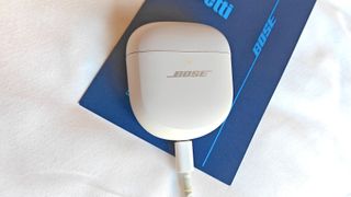 Bose QC Ultra Earbuds on charge in their case