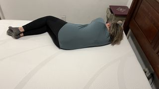 Tempur-Cloud mattress review image shows our main tester sleeping on her side