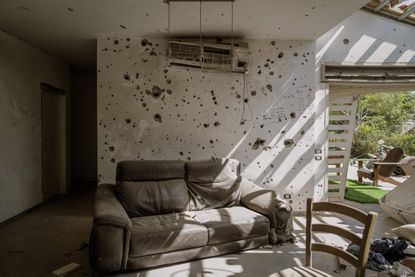 Sofa and bullet holes in Kibbutz Be'eri