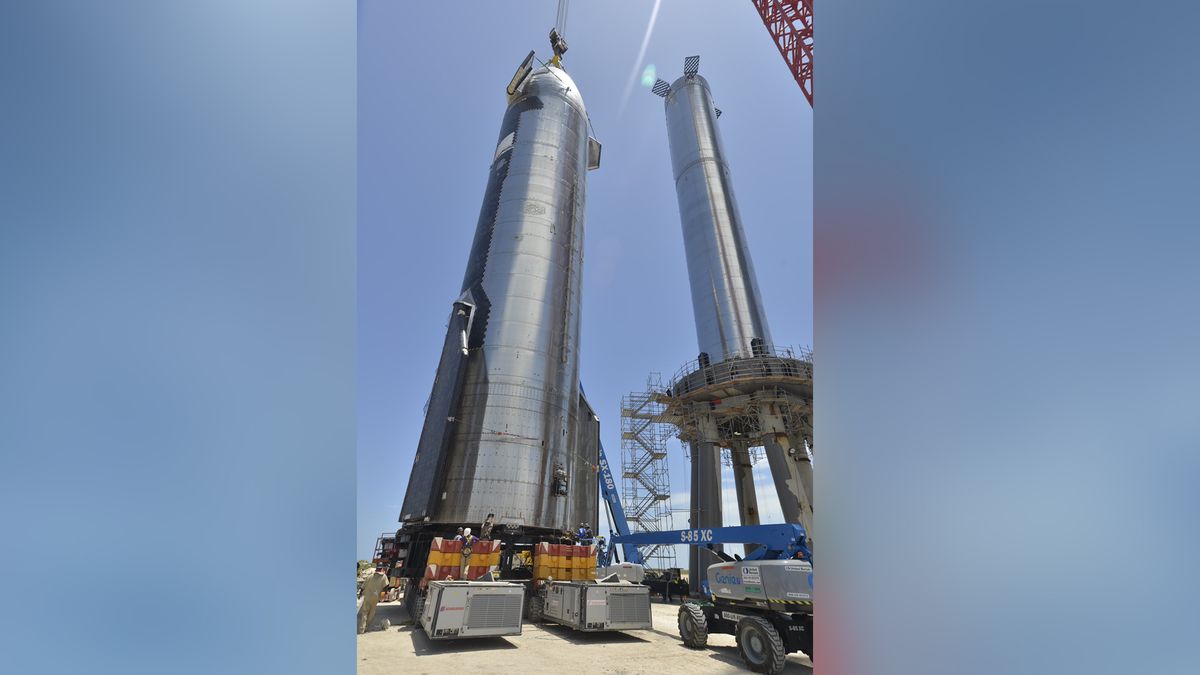 SpaceX's first orbital Starship SN20 is stacked atop its massive Super Heavy Booster 4 for the first time on Aug. 4, 2021 at the company's Starbase facility near Boca Chica Village in South Texas. They stood 395 feet tall, taller than NASA's Saturn V moon rocket.