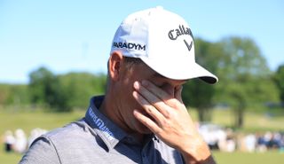 Dale Whitnell wipes away tears on the 18th green