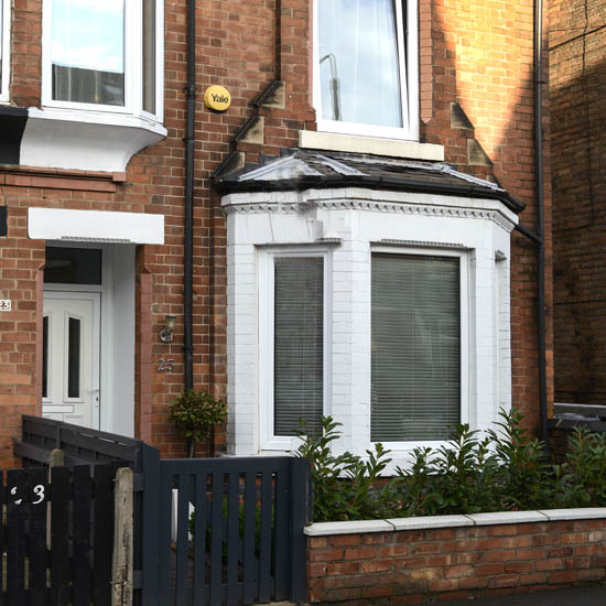house with exposed brick walls and white windows