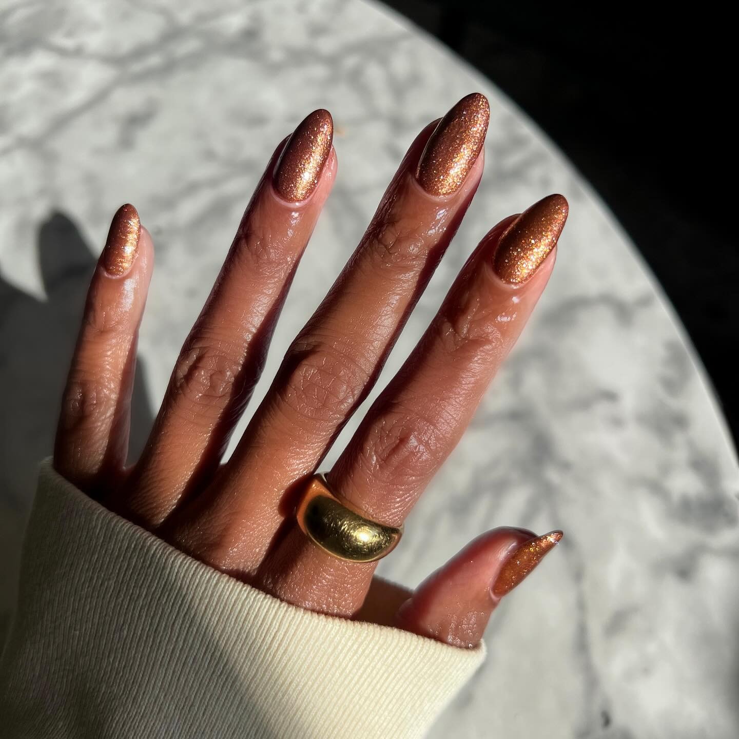 A shimmery, glittery, cinnamon-coloured manicure