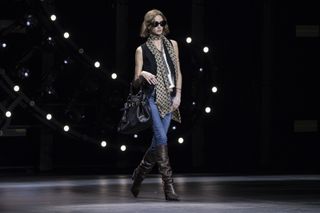 Celine runway show with woman in waistcoat and jeans