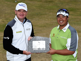 Paul Lawrie present Kiradech Aphibarnrat with the trophy at his own event
