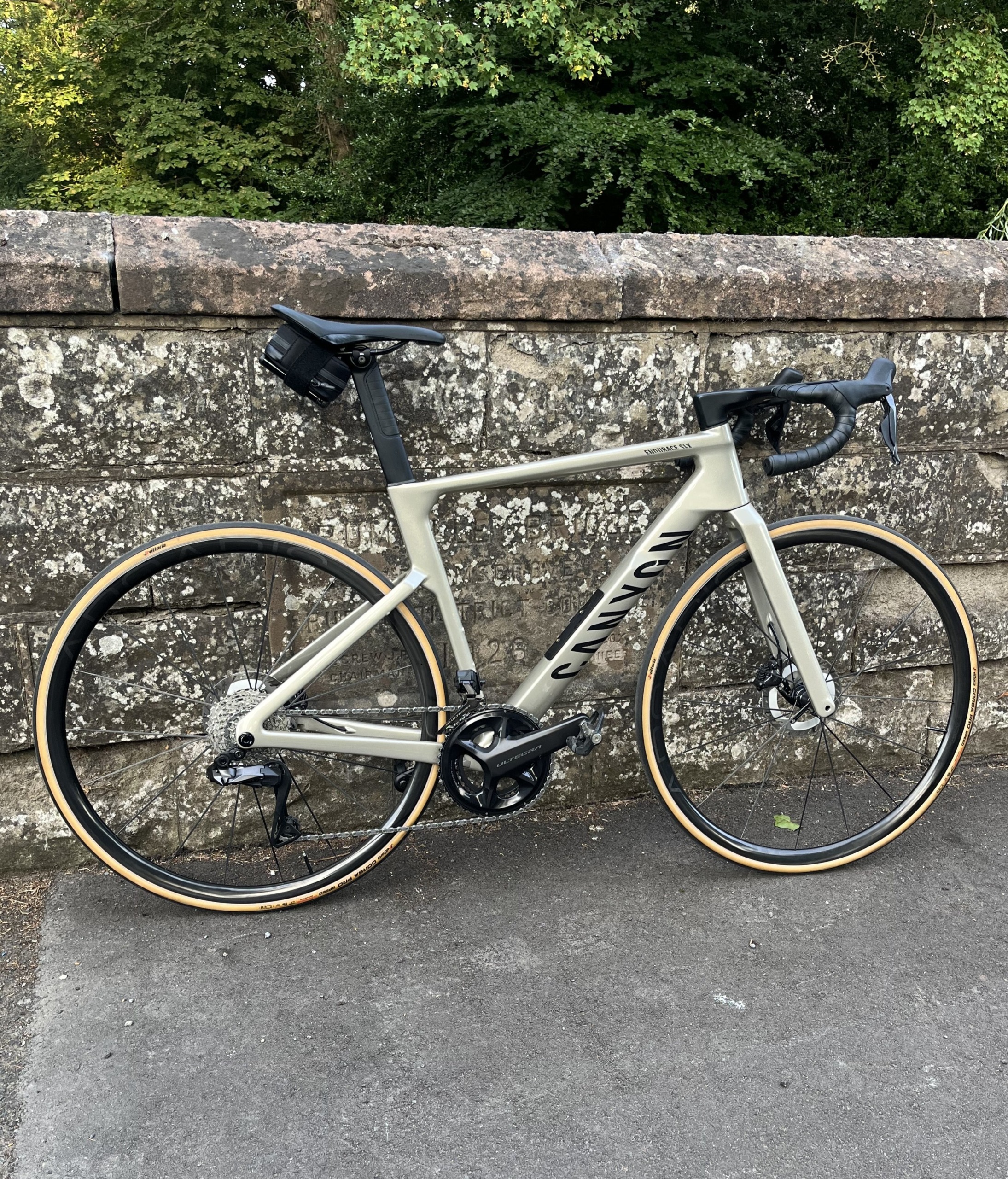 A Canyon Aeroad CF SLX leaning against a stone wall