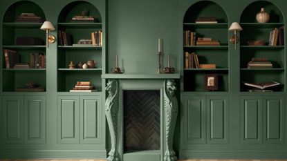 Built-in bookcase alcoves and a period fireplace painted in Webster Green by Benjamin Moore.