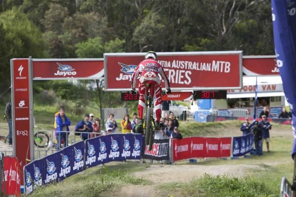 A rider flies through the air toward the finish.