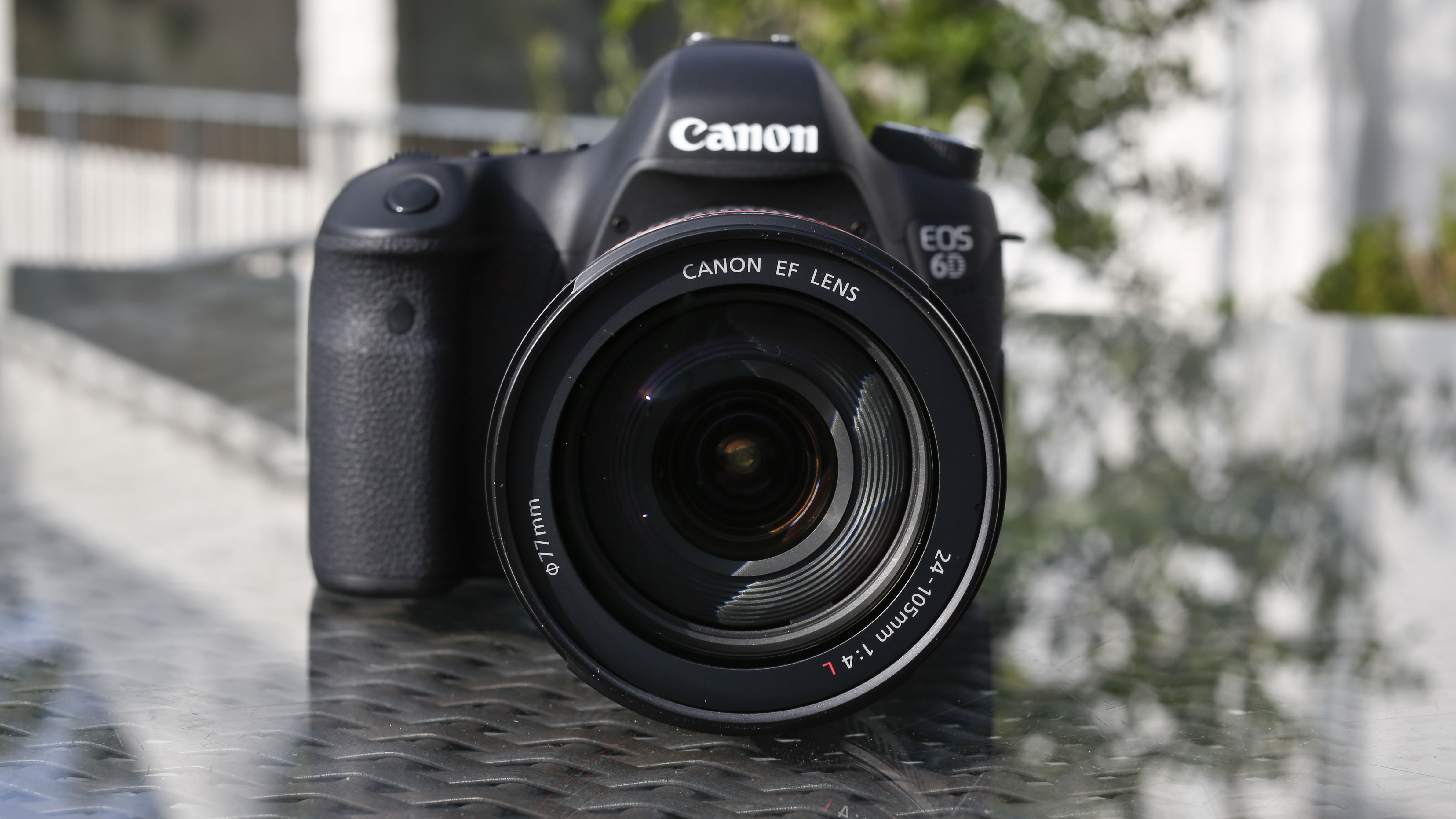The Canon EOS 6D DSLR on a glass table