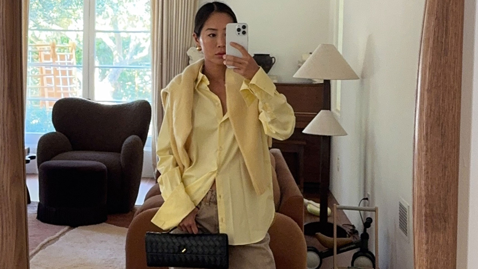 @aimeesong casual outfit selfie in yellow shirt and sweater
