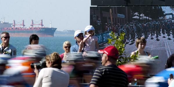 Riders speed past spectators along the esplanade in Geelong during the 122.7 kilometre women's road race.