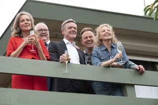 Stefan Dennis as Paul Robinson (centre) with Annie Jones as Jane Harris, Ian Smith as Harold Bishop, Jason Donovan as Scott Robinson, and Kylie Minogue as Charlene in the final episode of Neighbours.