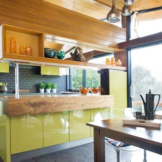 kitchen area with yellow cabinetry
