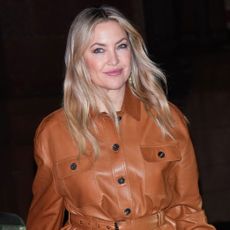 Kate Hudson wears a brown jacket