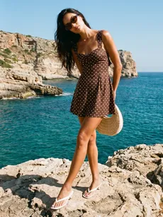 A revolve model standing on a rock by the sea