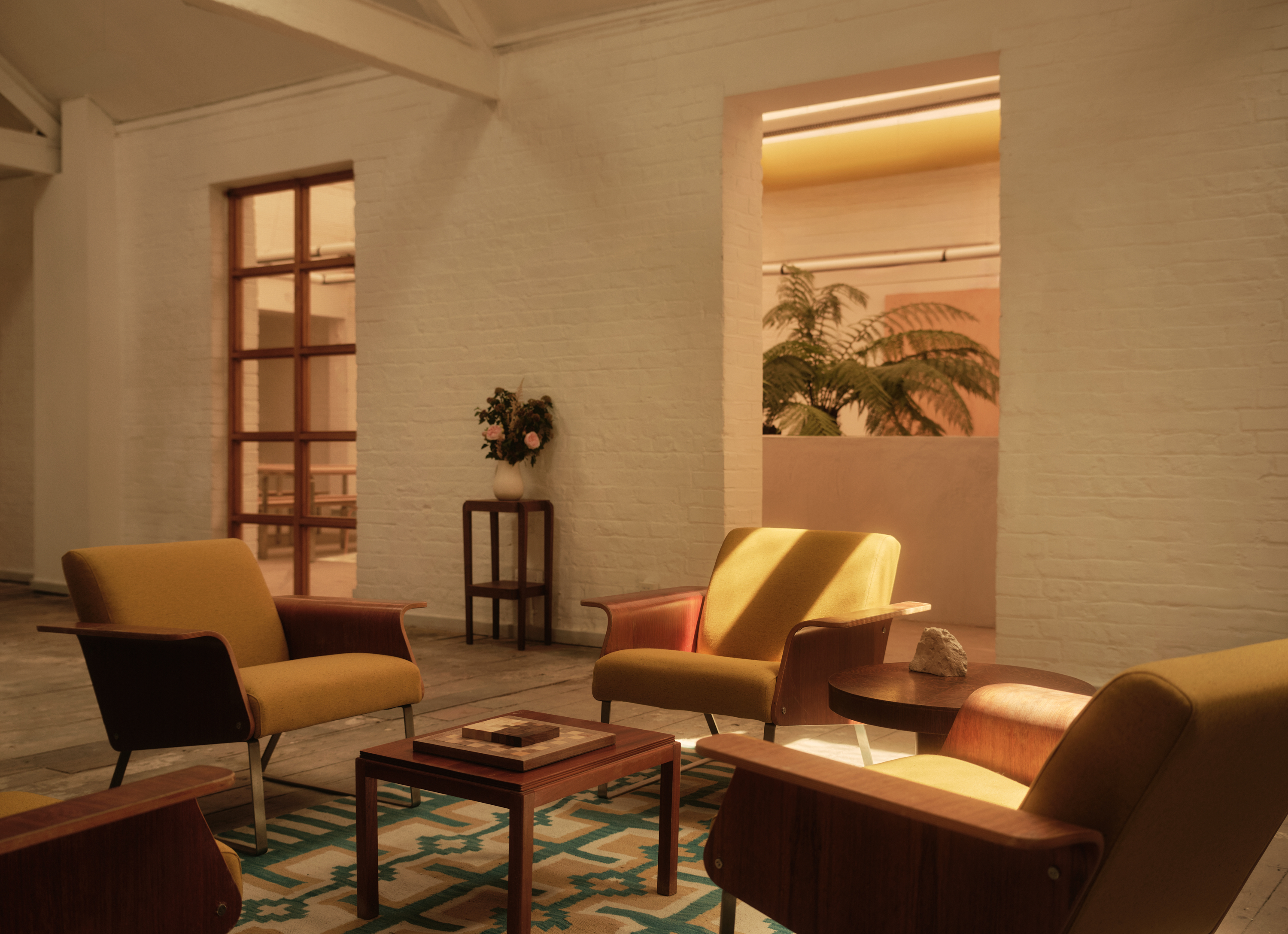 new Cubitts headquarters interior, refurbished warehouse type building with raw materiality and colour pops
