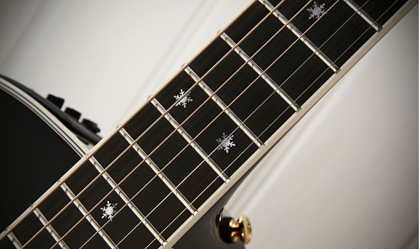 The 644mm (25.3-inch) scale neck has a white- bound ebony fingerboard with mother-of-pearl 'snowflake inlays
