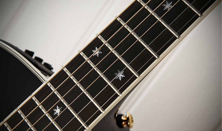 The 644mm (25.3-inch) scale neck has a white- bound ebony fingerboard with mother-of-pearl 'snowflake inlays