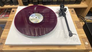 Rega Planar 3/Nd3 turntable package top-down angle with purple vinyl on platter