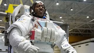 an astronaut up in a spacesuit inside a big-ass warehouse