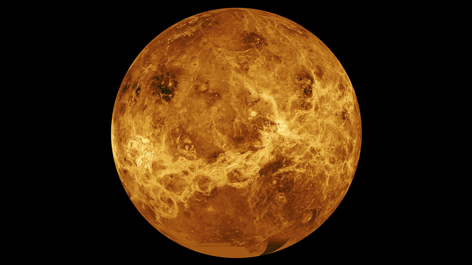 Orange brown planet Venus against the black backdrop of space.