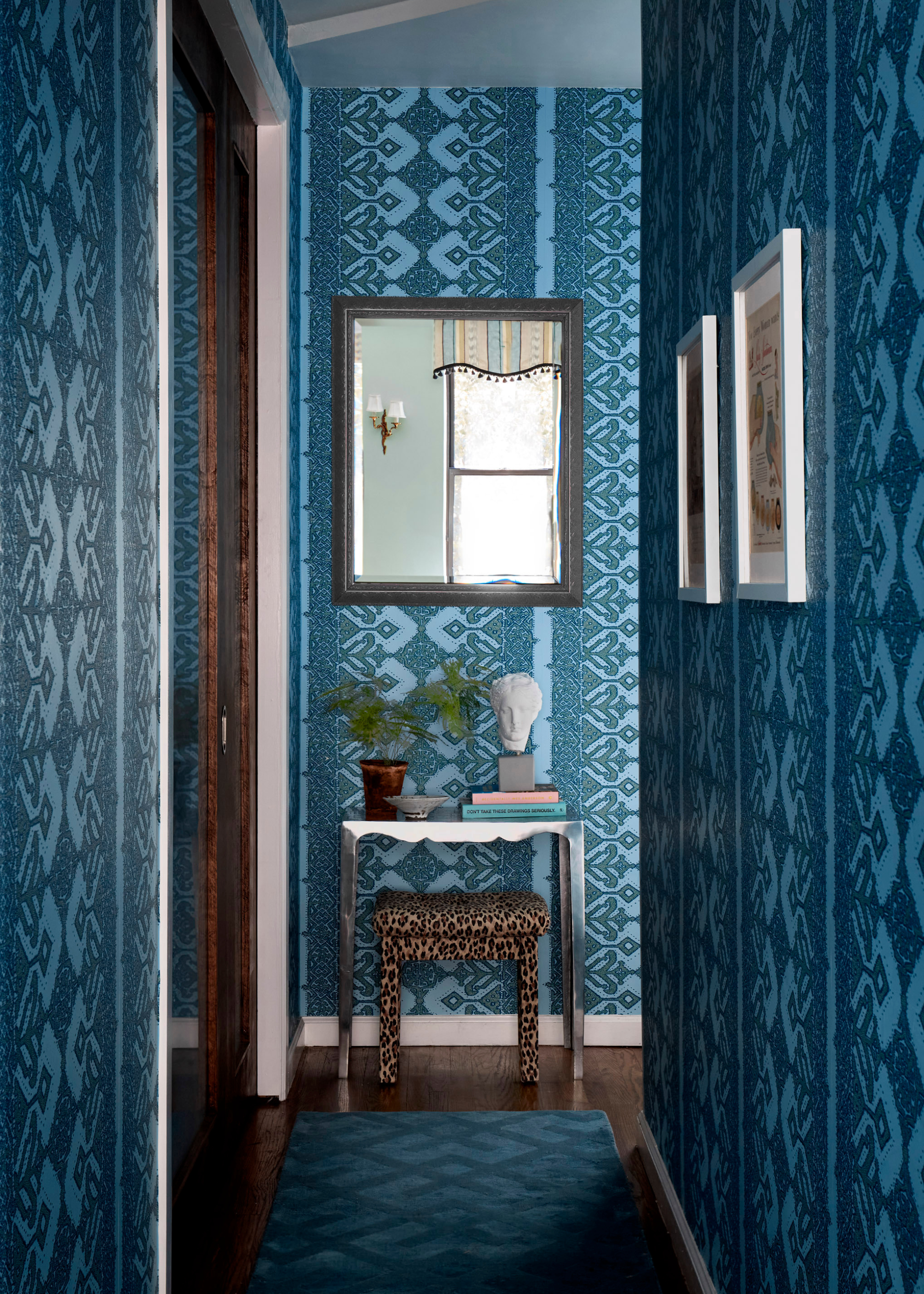 a rich teal blue room with wallpaper that matched the dark carpets