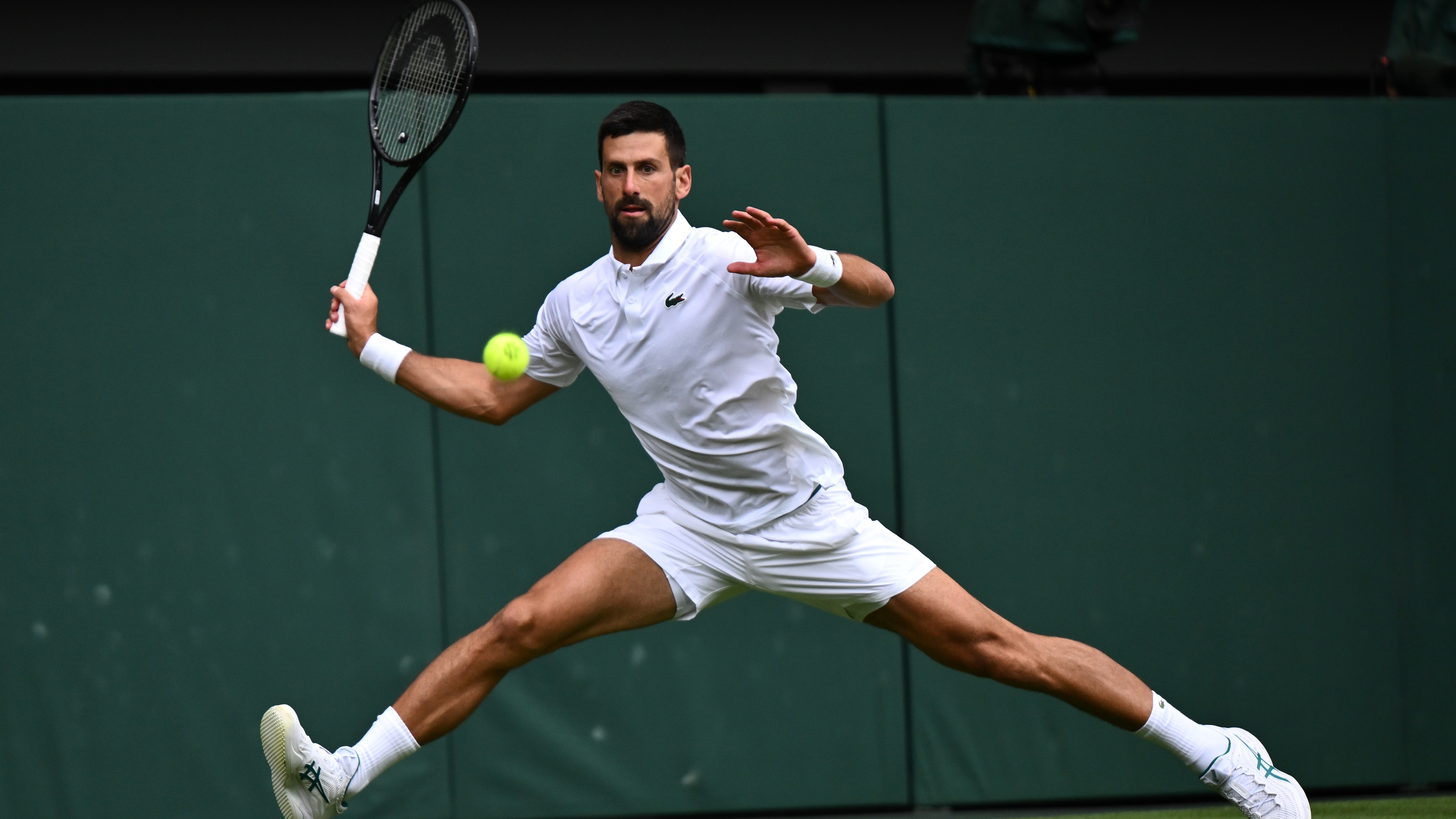 Novak Djokovic reaches for a shot playing at Wimbledon 2025