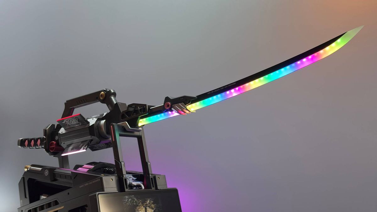 An RGB samurai sword on a pedestal that is actually a PC. The words 'Shugo' can be seen on the wall behind the exhibition piece from Corsair.