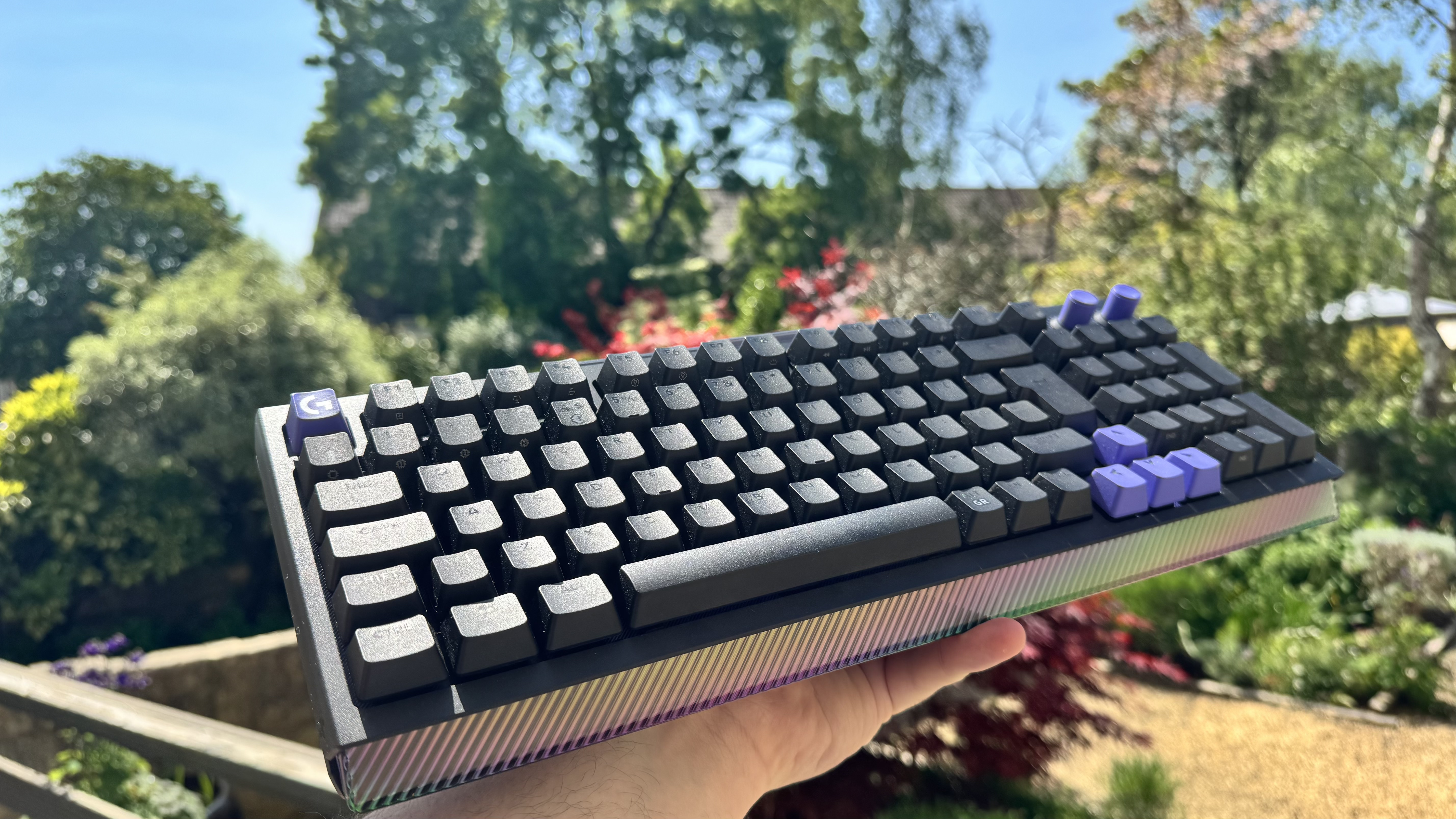 The Logitech G512 X gaming keyboard from the front left, held outside