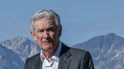 Federal Reserve Chair Jerome Powell in front of mountain range at Jackson Hole, Wyoming.