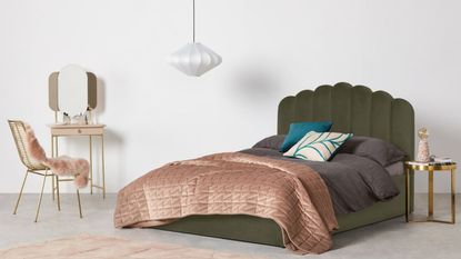 MADE.com Delia King Size Ottoman Storage Bed in green, one of the best storage beds, dressed inside a bedroom with grey bedding and pink decor