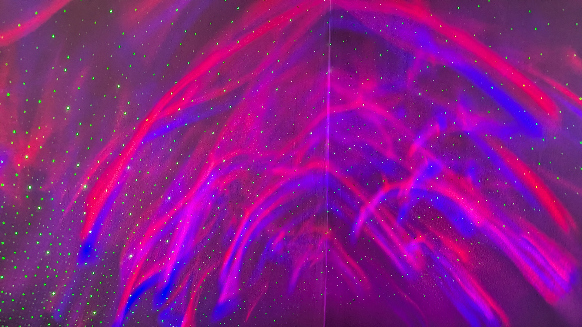 YgiTK Northern Galaxy Lights Projector during Review, on a wooden table against a dark coloured wall