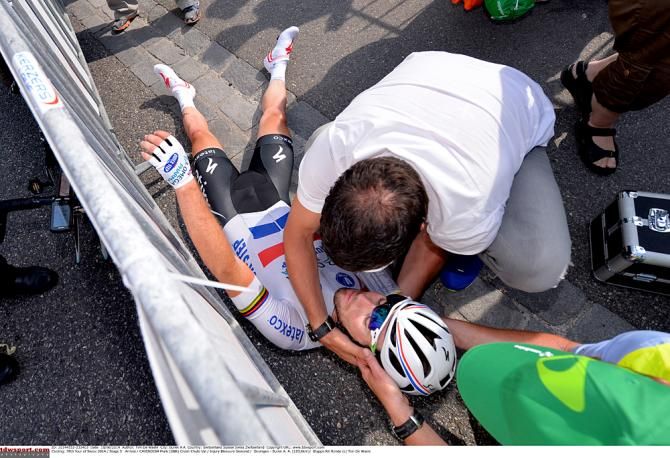 Mark Cavendish (Omega Pharma-Quickstep) is checked over by the medical staff