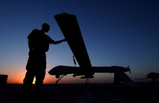A crew chief from the 46th Expeditionary Reconnaissance Squadron completes post flight inspections of an RQ-1 Predator on Sept. 15, 2004, at Balad Air Base in Iraq.