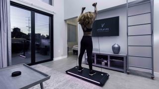 Person using the Vitruvian V-Form Trainer in their living room