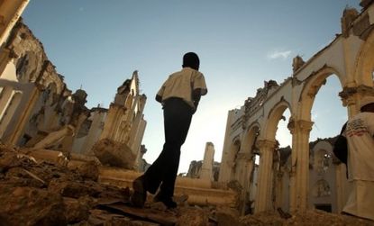 A boy walks through the destroyed Port-au-Prince cathedral before the anniversary services began. Less than a tenth of the rubble has been cleared in the capital city.