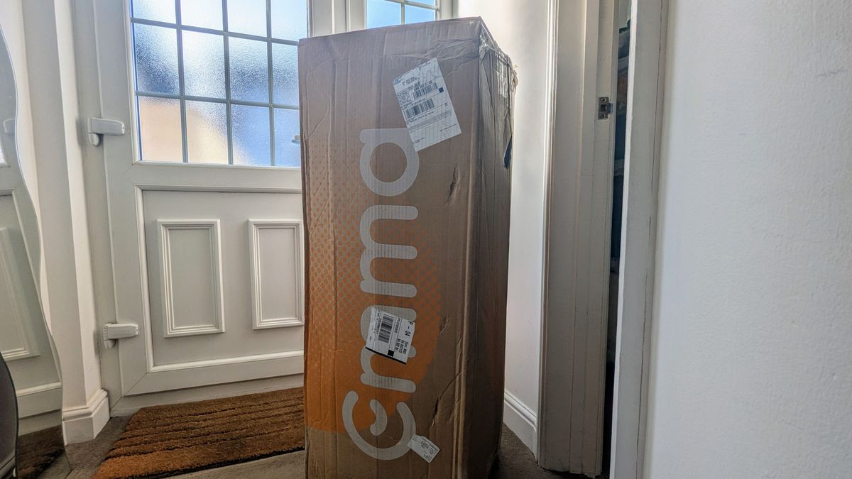 A boxed Emma Hybrid Airgrid mattress kept near the front door
