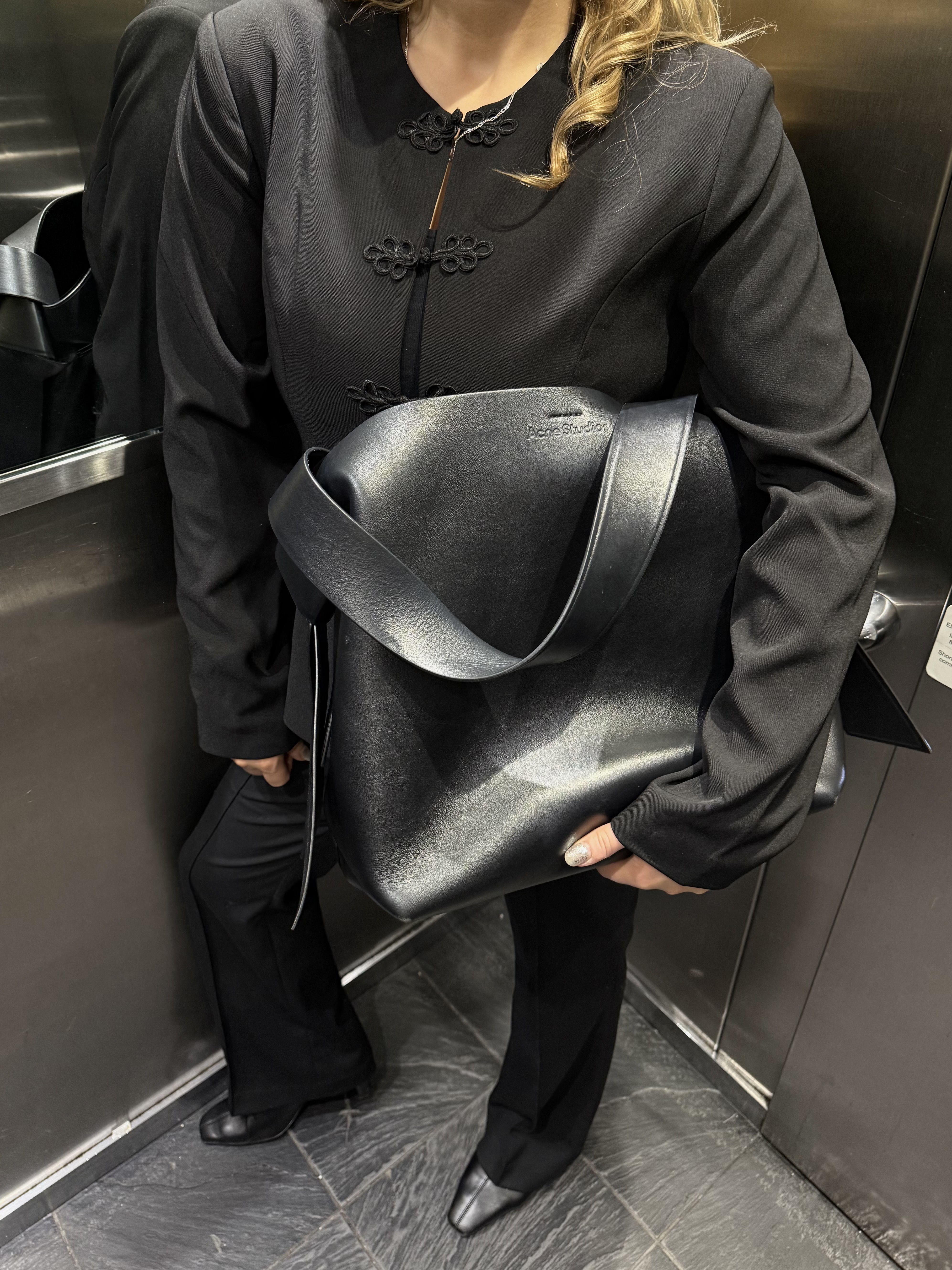 An image ofBest Knockoff Luxury Clothing
 UK Acting Deputy Editor, Rebecca Rhys-Evans, reviewing the Acne Musubi bag.