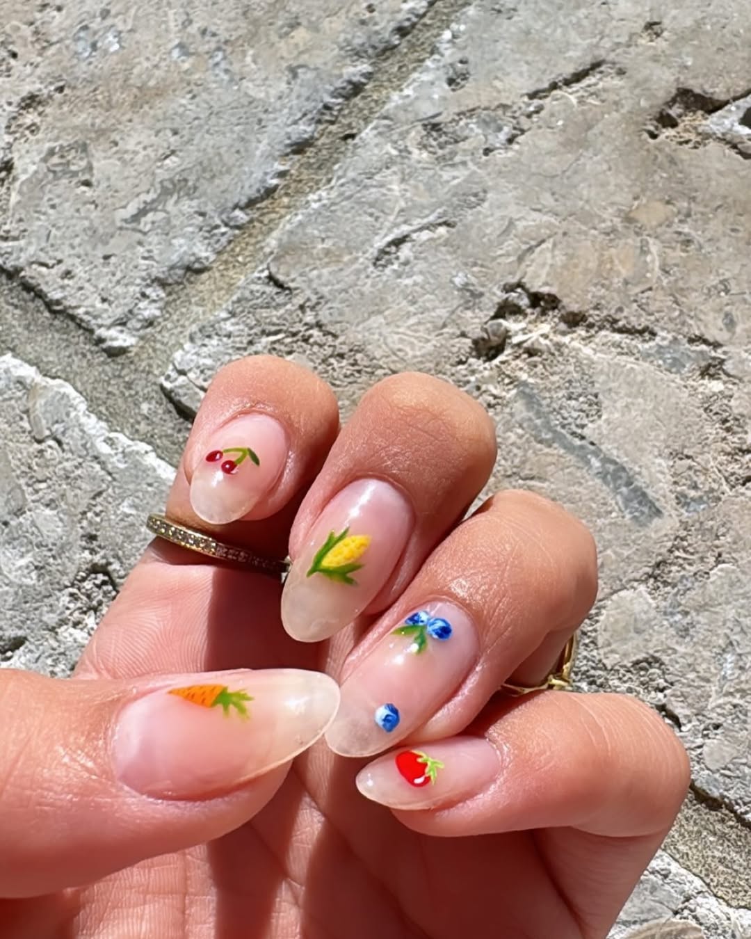 a person wearing a fruit manicure