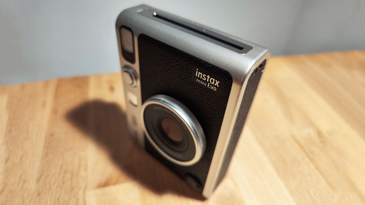 The Fujifilm Instax Mini Evo on a wooden table