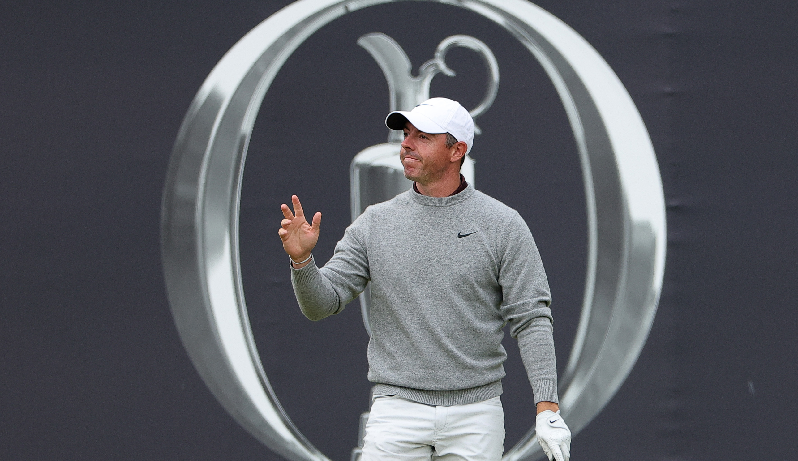 Rory McIlroy waves to fans on the opening tee