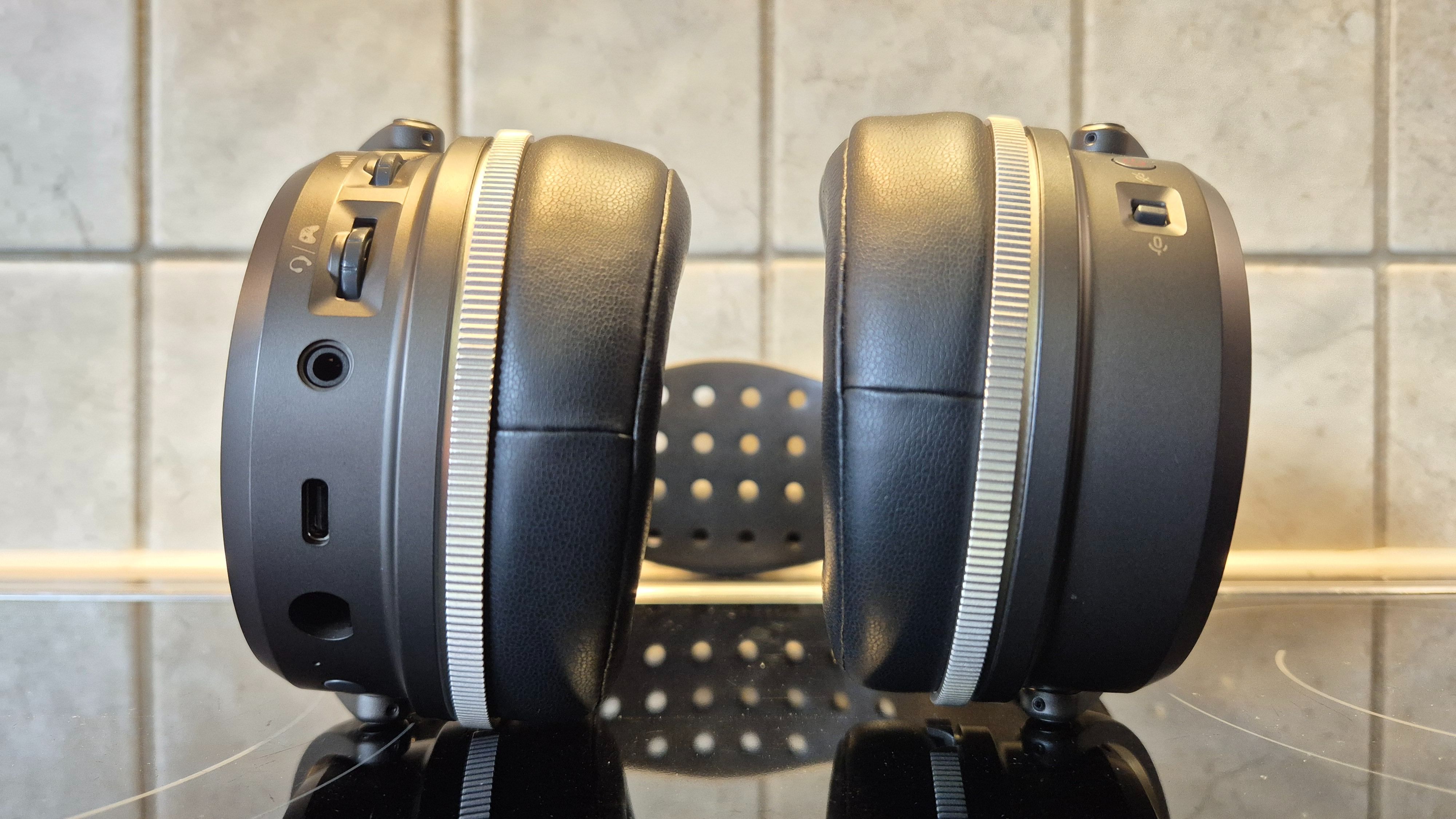 A picture of the Audeze Maxwell 2 ANC gaming headset sitting on a shiny surface with pale tiles in the background