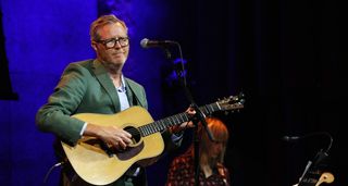 Robbie Fulks plays an acoustic guitar at Wesley Stace's Cabinet of Wonders Variety Show at City Winery on September 7, 2025.